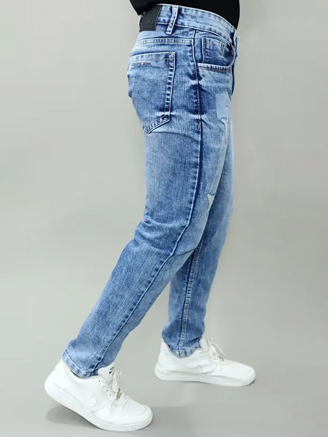 Full length side view of Gex Jeans G828 light blue patched denim