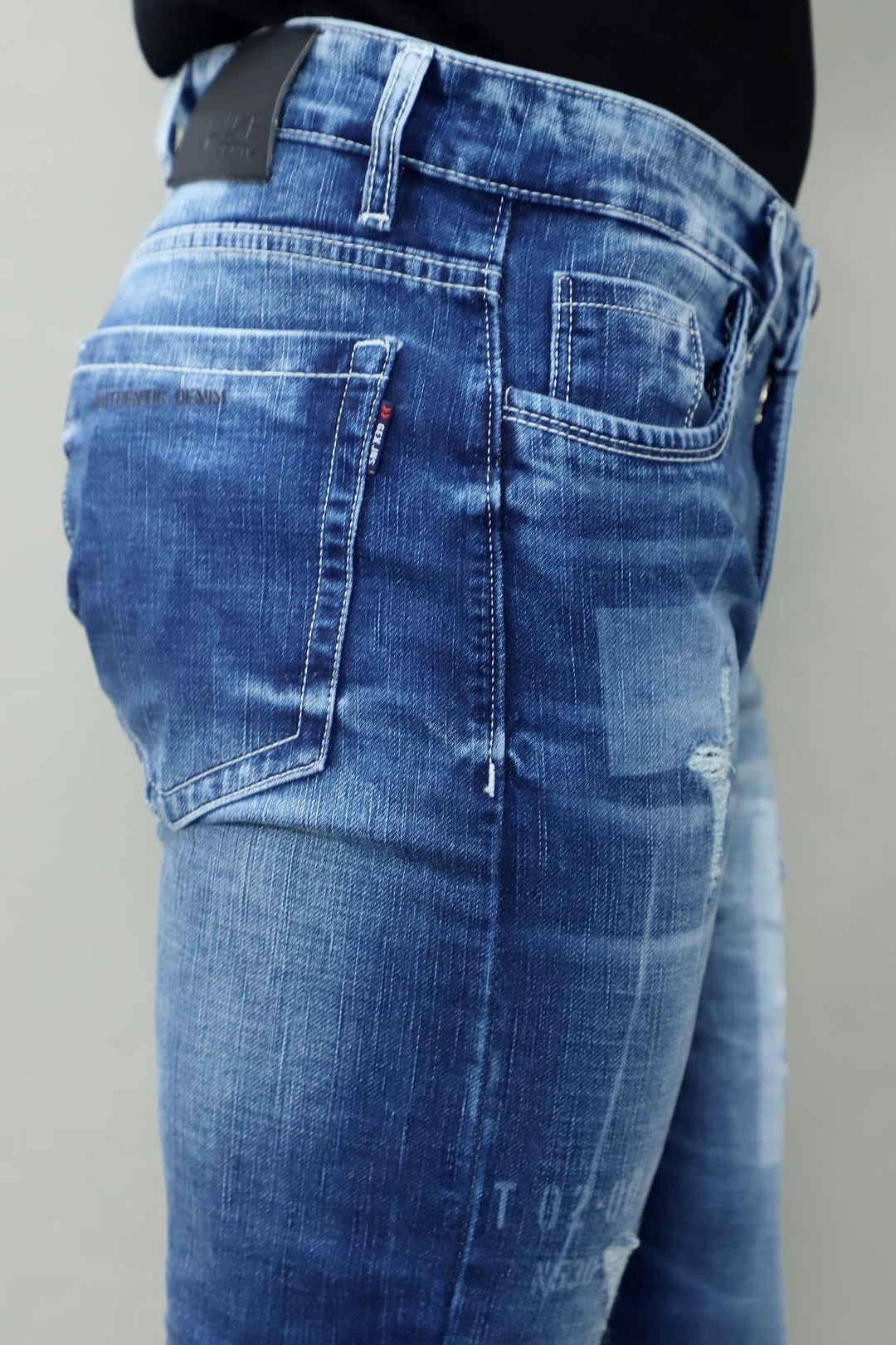 Full length view of GEX men's blue distressed slim fit stretch jeans E13