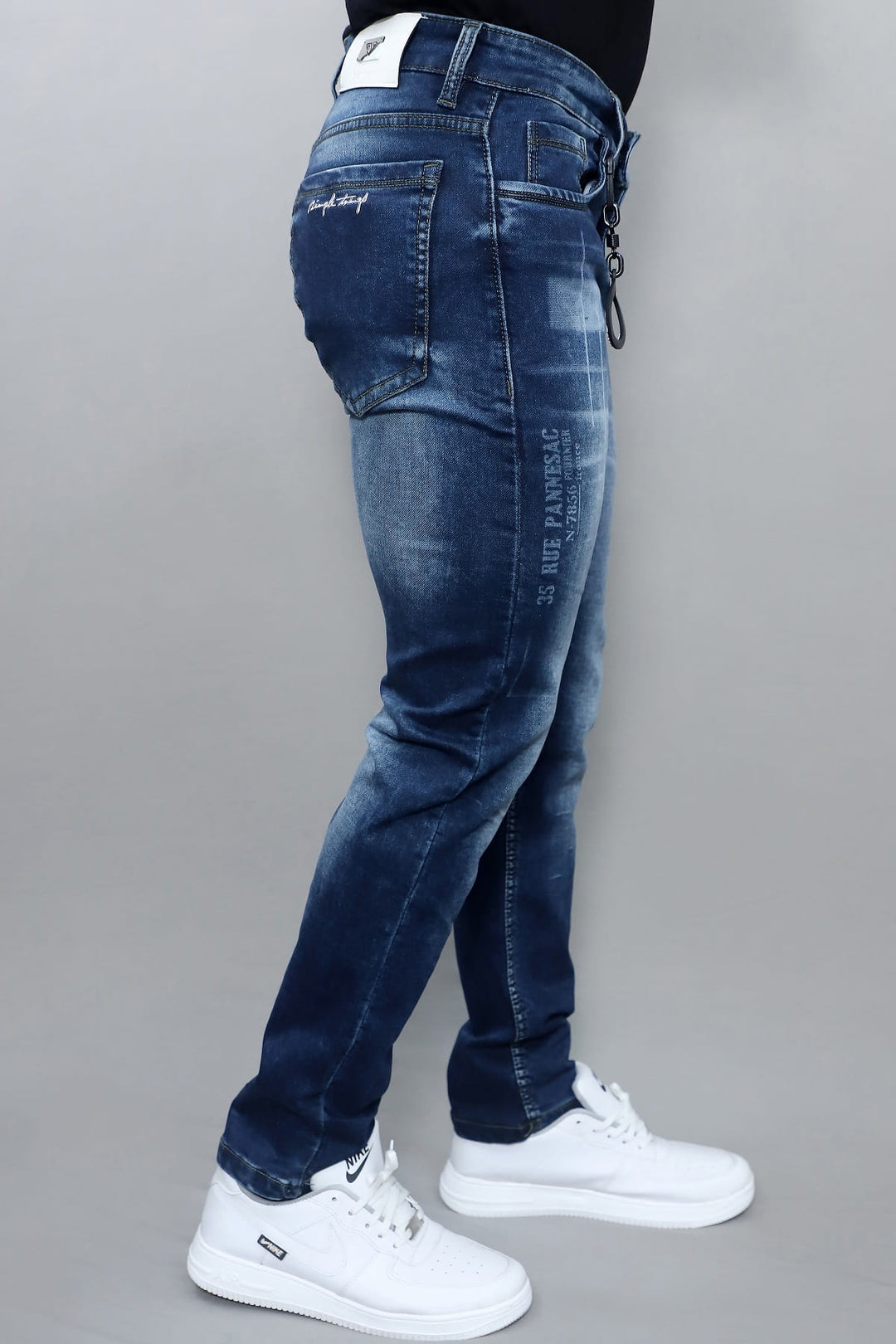 Waist and pocket detail of men's premium dark blue washed slim fit stretch jeans E19