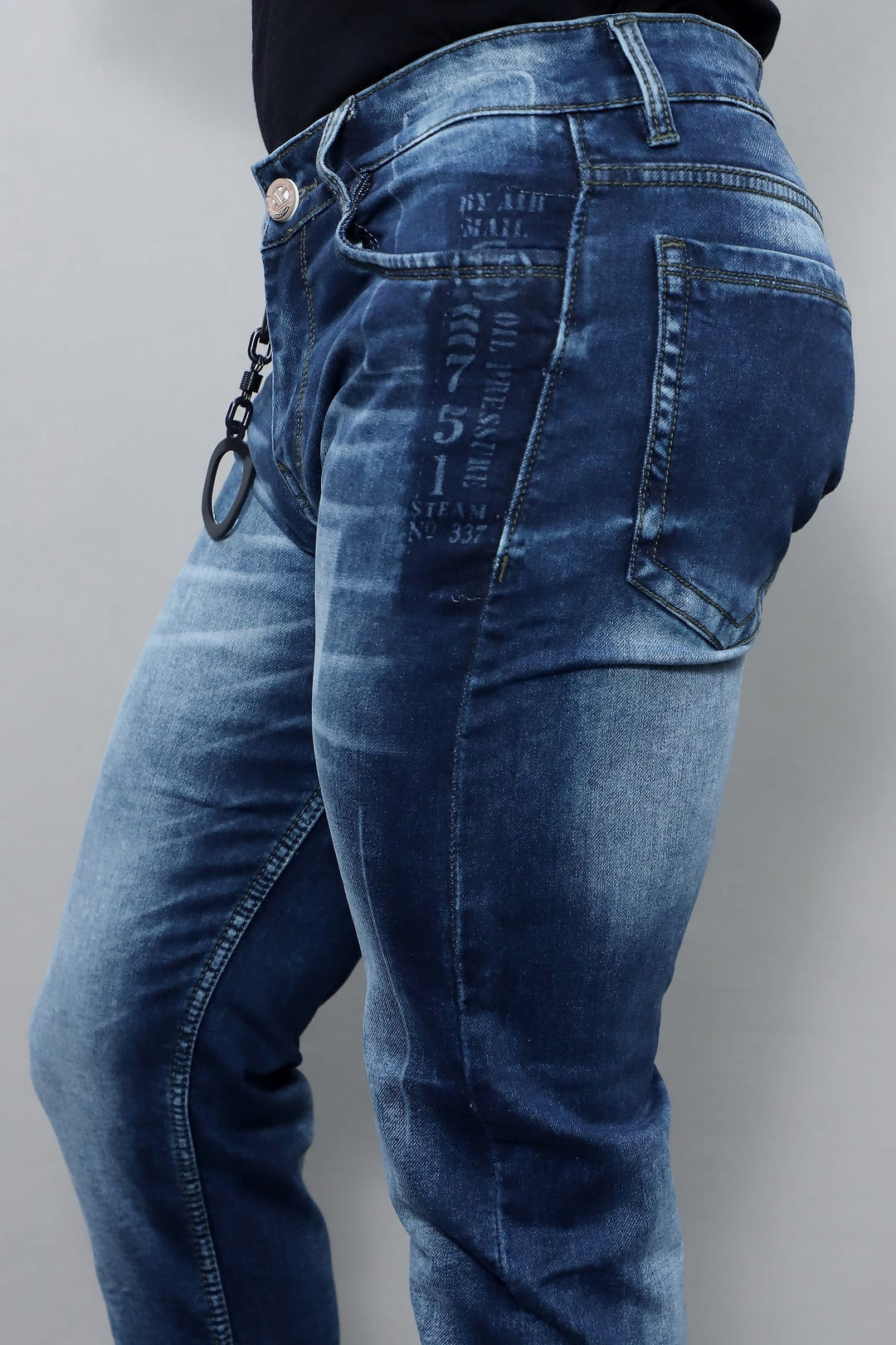 Close up of dark blue washed stretch denim fabric in men's slim fit jeans E19