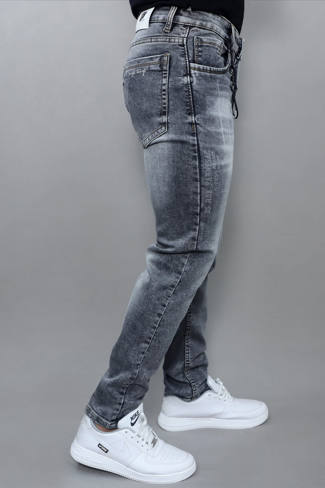 Waist and pocket detail of men's premium grey washed slim fit denim jeans E19
