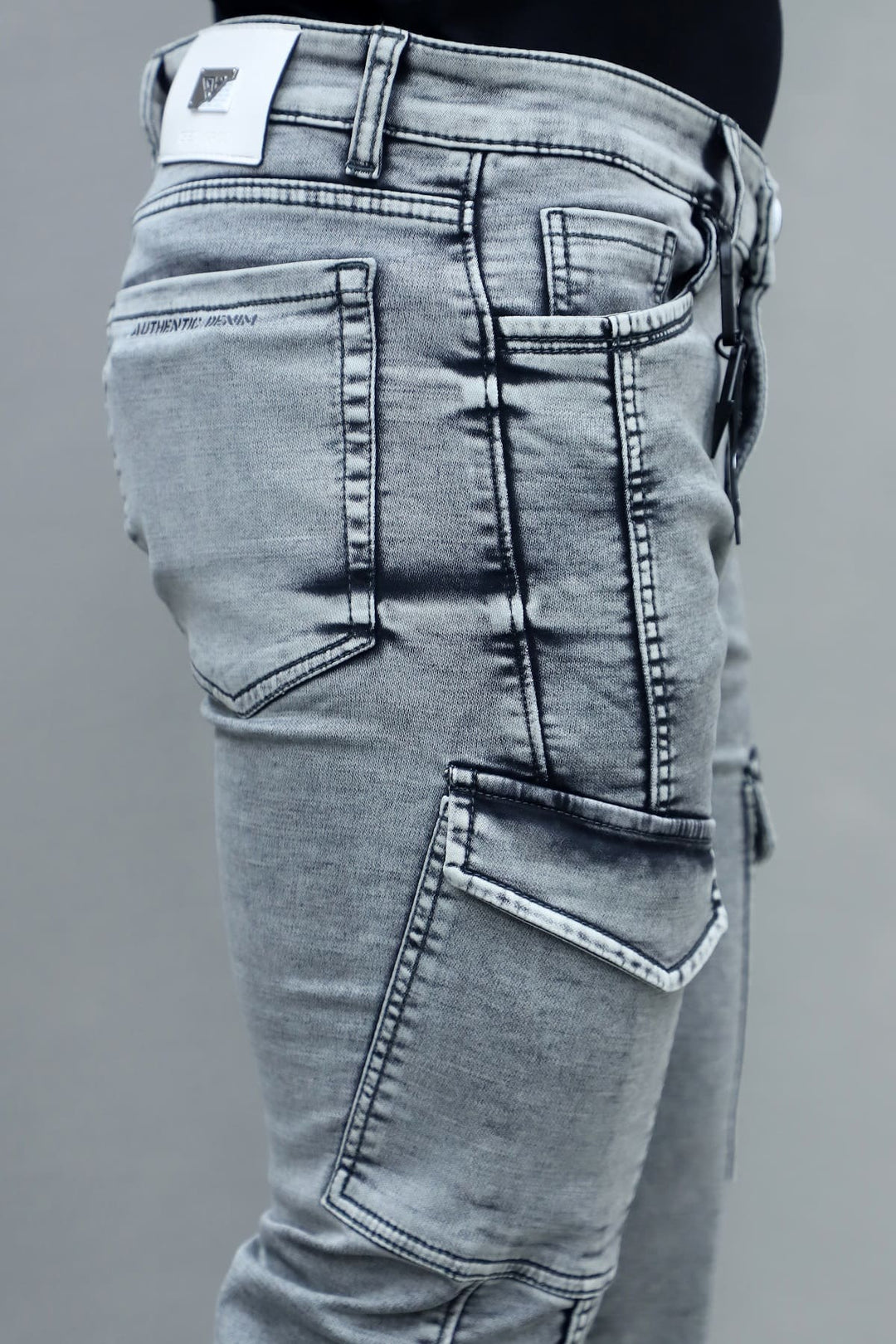 Close up of light grey stretchable fabric in men's slim fit 6 pocket cargo jeans E-15