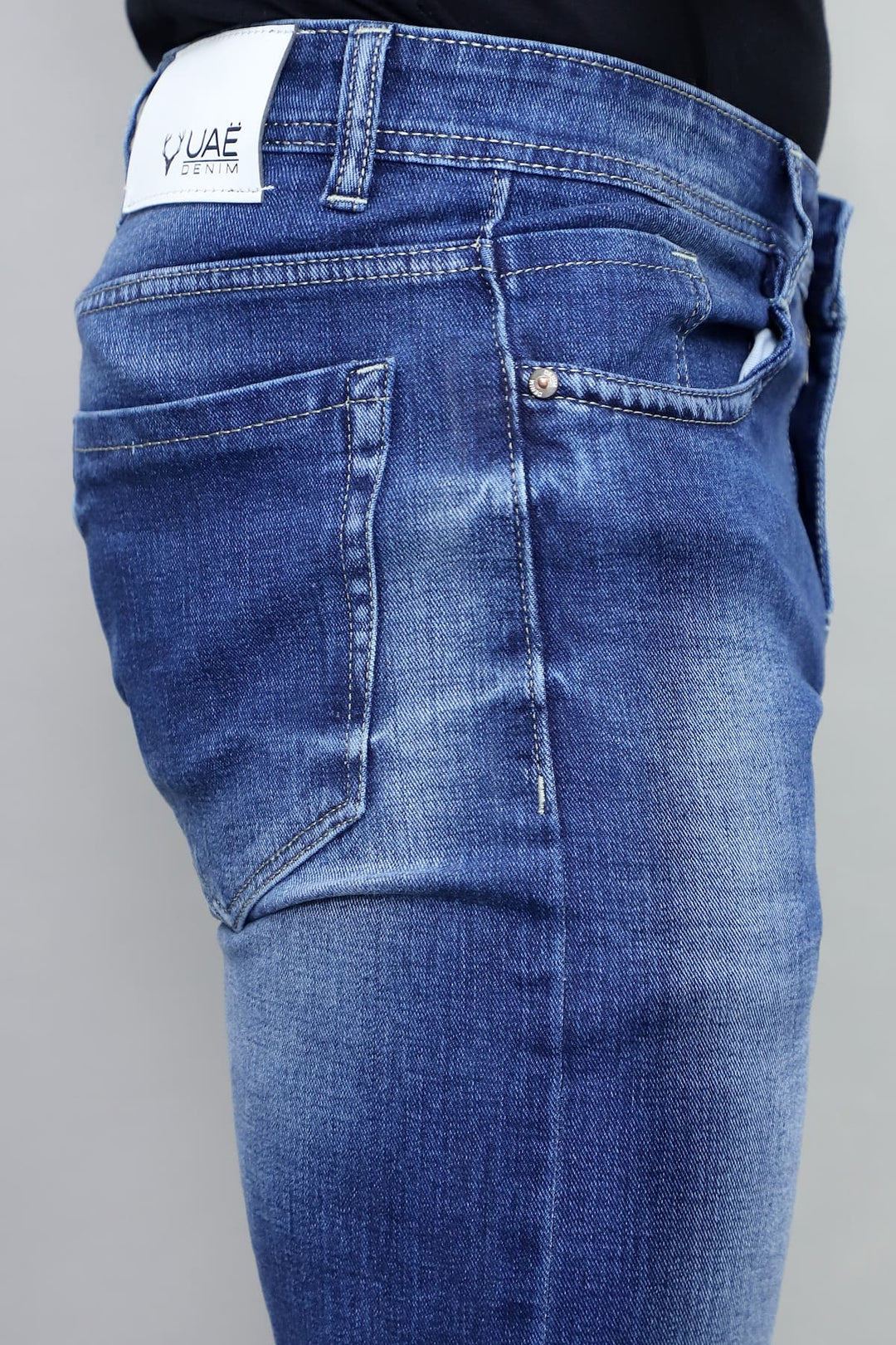 Full length view of men's slim fit royal blue washed stretchable denim jeans E9