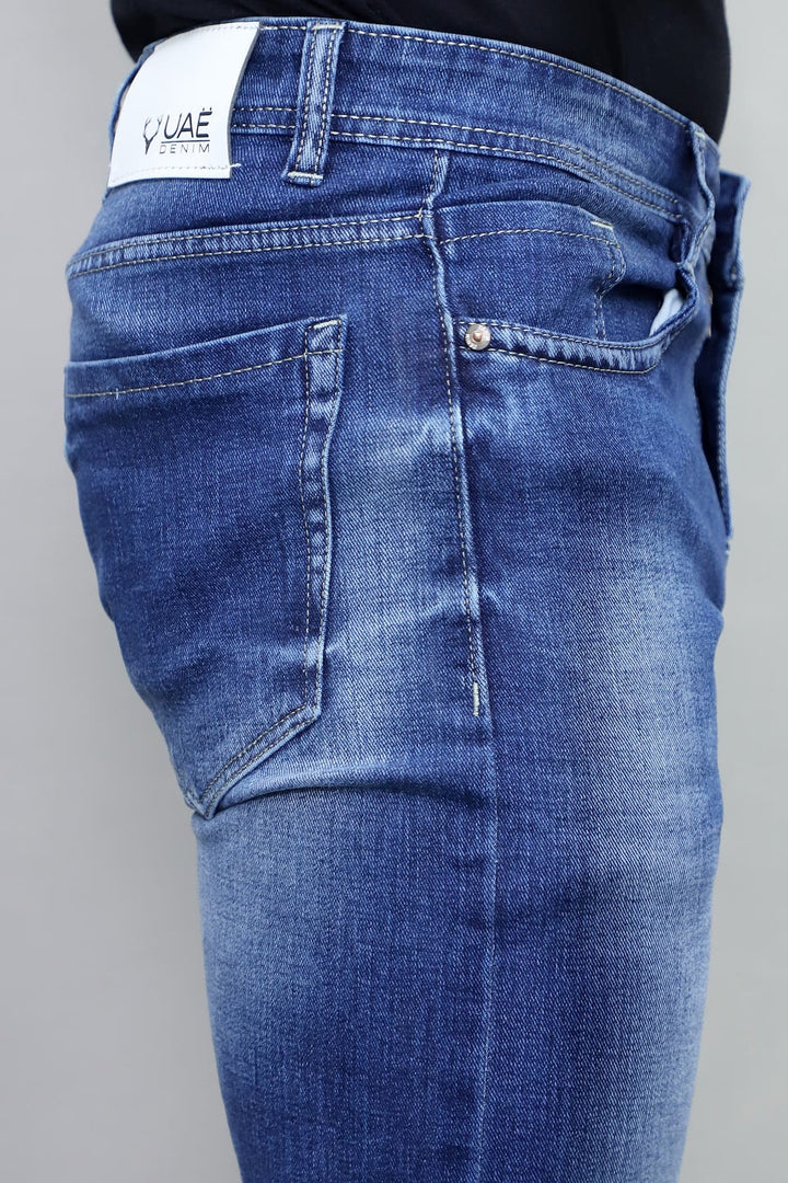 Full length view of men's slim fit royal blue washed stretchable denim jeans E9
