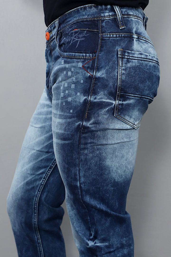 Model wearing regular fit blue jeans for men mid rise comfort article no Gex plain blue styled for casual everyday look